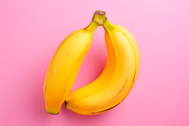 Fresh yellow bananas on pink background