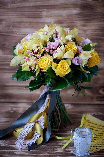 Fresh yellow bouquet of yellow roses and pink berriesBright colors