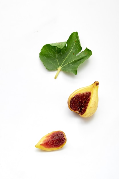 Fresh yellow figs fruit with leaf on white