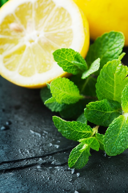 Fresh yellow lemon and green mint on the table