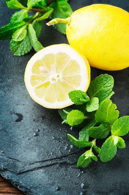 Fresh yellow lemon and green mint on the table