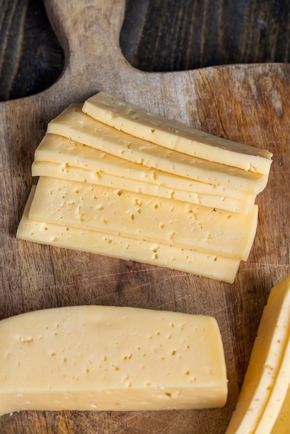 Fresh yellow milk cheese on a board