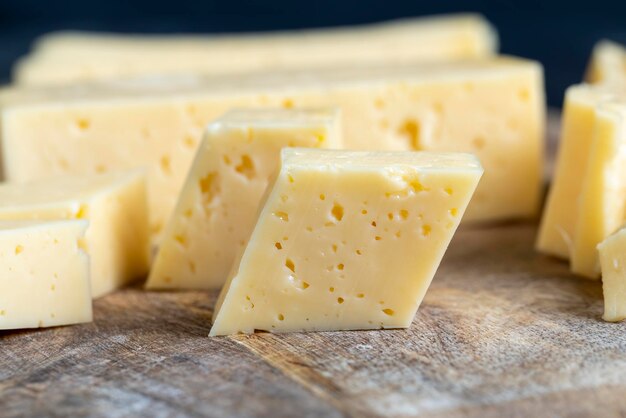Fresh yellow milk cheese on a board