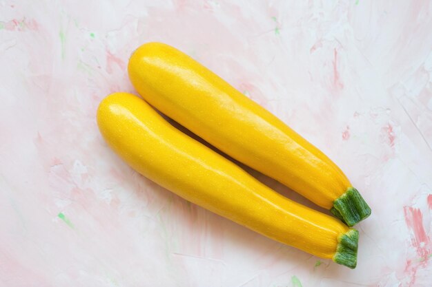 Fresh yellow squash on a pink background healthy vegetables ingredient for cooking
