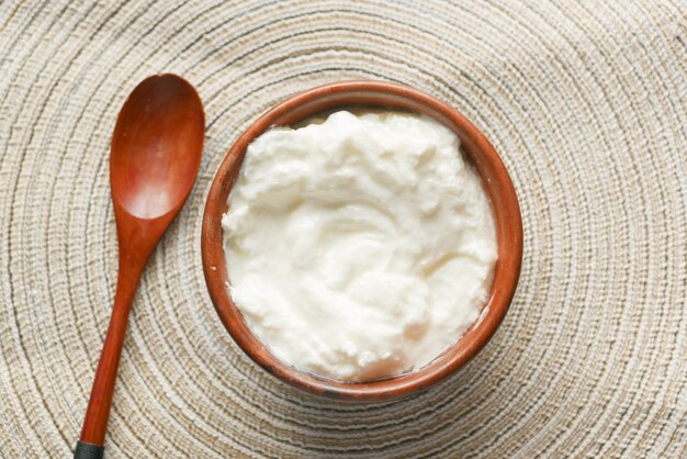 Fresh yogurt in a bowl on table