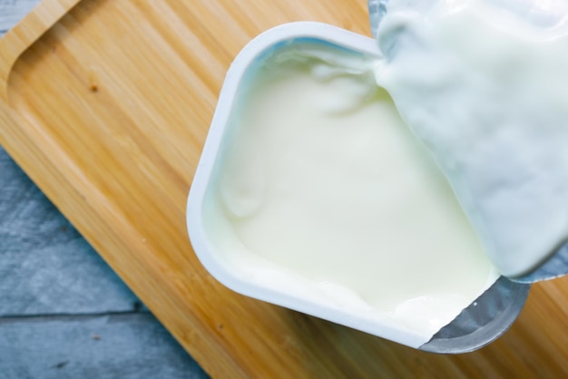 Fresh yogurt in a bowl on table