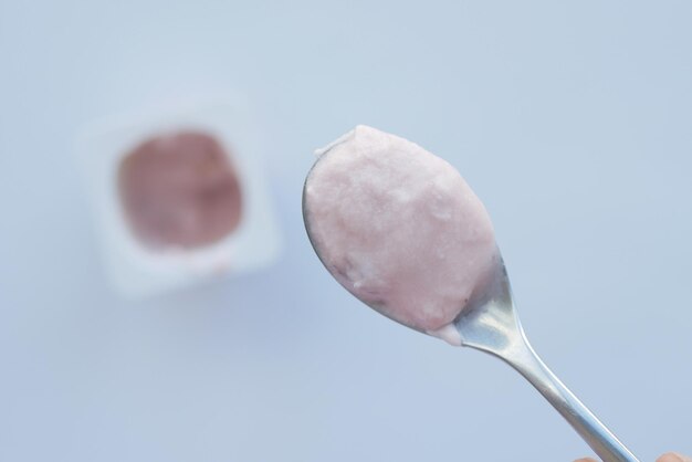 Fresh yogurt on spoon top view