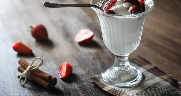 Fresh yogurt with berries. Ice cream in a bowl with fresh and juicy strawberries and cherries. Dessert with red berries.