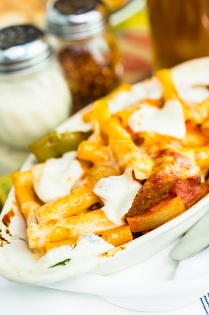 Fresh ziti pasta with sausage in Italian restaurant.