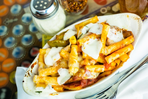 Fresh ziti pasta with sausage in Italian restaurant.