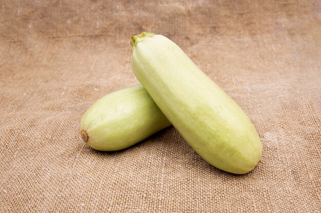 Fresh zucchini isolated on a fabric background