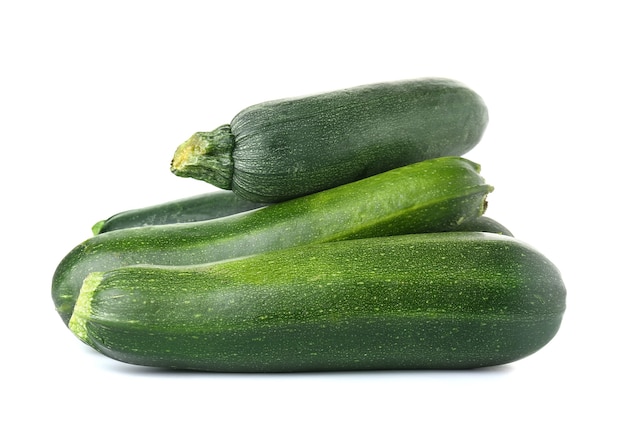 Fresh zucchini squashes on white background