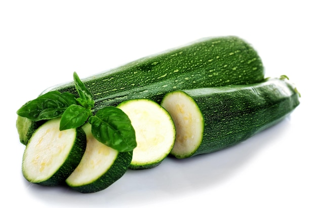 Fresh zucchini with basil isolated on white