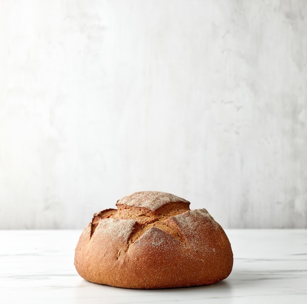 Freshly baked artisan bread on light kitchen table