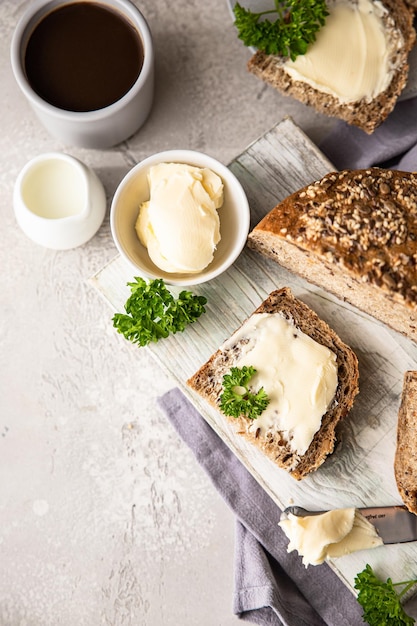 Freshly baked artisan multigrain bread with butter and pate