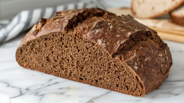 Freshly Baked Artisanal Whole Grain Rye Bread Loaf on Marble Kitchen Surface