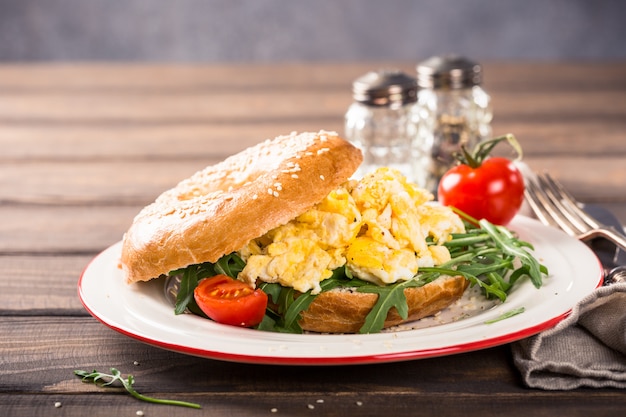 Freshly baked bagel filled with scrambled eggs