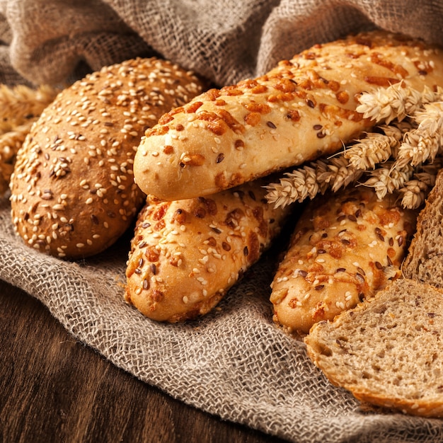 Freshly baked bread assortment on wooden board