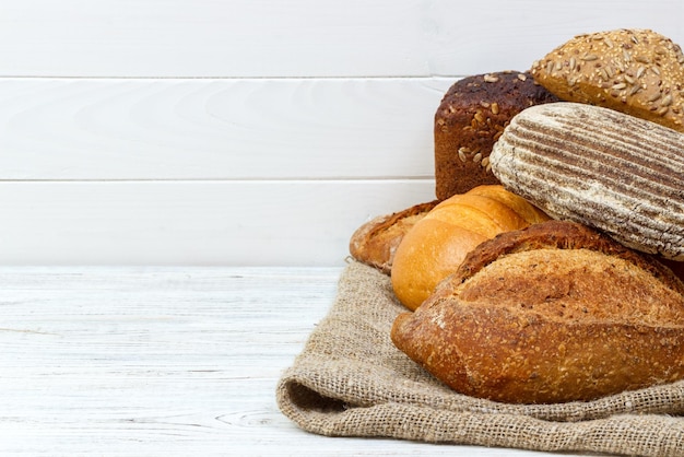 Freshly baked bread assortment on wooden table