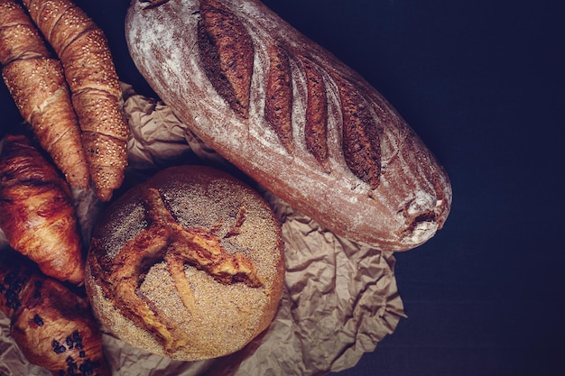 Freshly baked bread, croissants, and bagels with seeds on top.