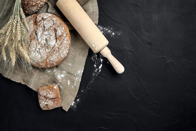 Freshly baked bread on dark kitchen table top view