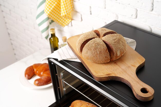 Freshly baked bread in mini oven in the kitchen