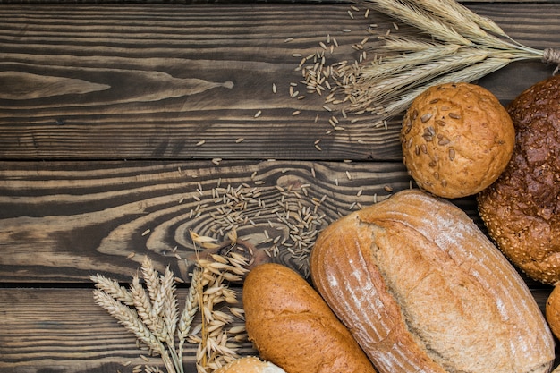 Freshly baked bread products on wooden background