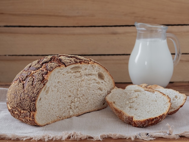 Freshly baked bread sliced on rustic table