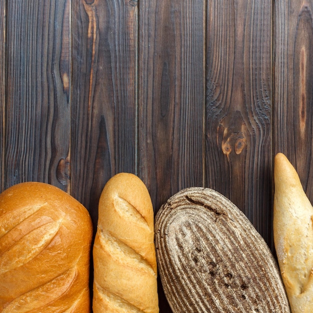 Freshly baked bread on wooden background top view