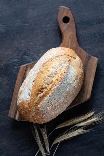 Freshly baked bread on wooden cutting board