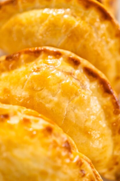 Freshly baked breakfast empanadas with eggs and sweet potato on the kitchen counter