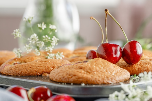 Freshly baked cherry muffins with fresh berries