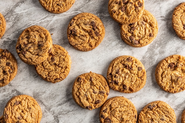 Freshly baked Chocolate chip cookies on a marble countertop.