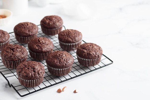 Freshly baked chocolate muffins on a grid