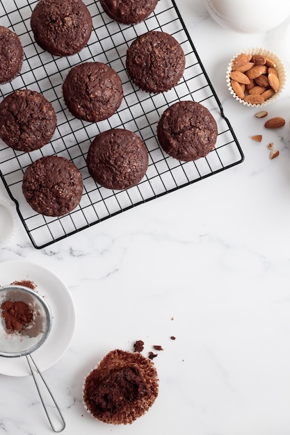 Freshly baked chocolate muffins on a grid