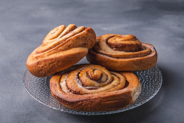 Freshly baked cinnamon buns on a plate.