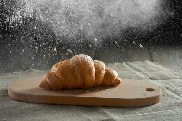 Freshly baked croissants on wooden table