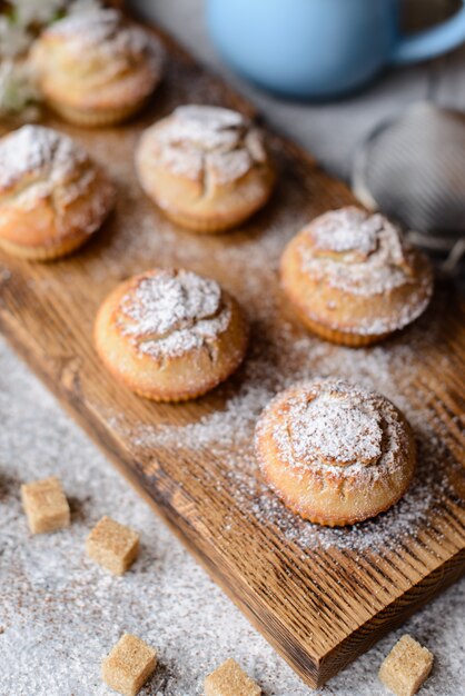 Freshly baked cupcakes with powdered sugar