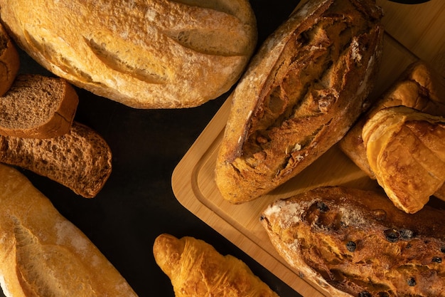 Freshly baked delicious bread on a rustic wooden worktop flat lay top view