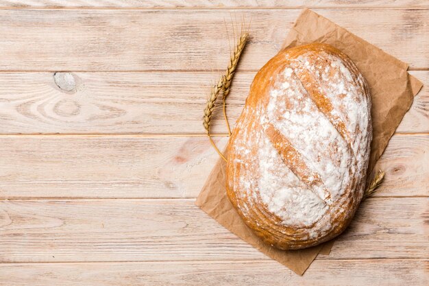 Freshly baked delicious french bread with napkin on rustic table top view Healthy white bread loaf