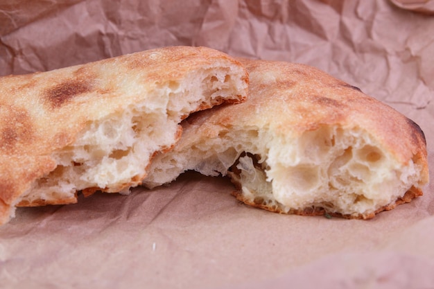 Freshly baked georgian pita bread on parchment paper. delicious simple food. close-up