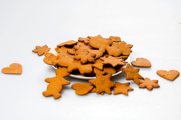 Freshly baked gingerbread on a white plate isolated on white copy space closeup