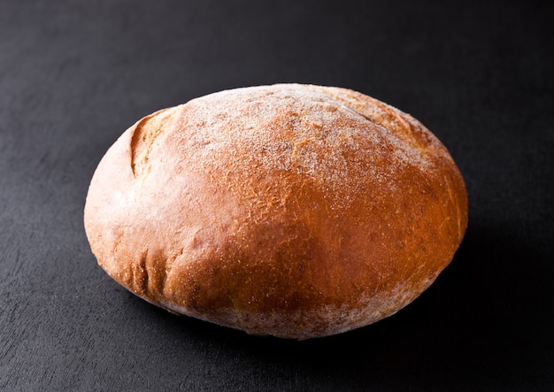 Freshly baked gluten free organic bread on black background