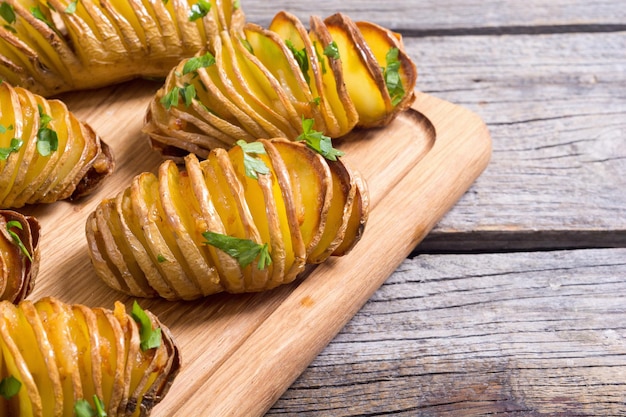 Freshly baked hasselback potatoes with parsley