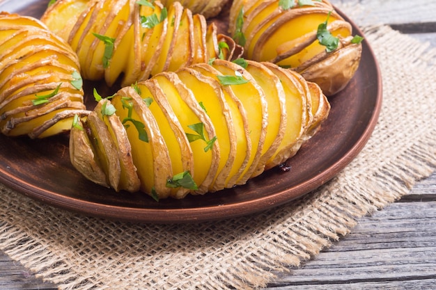 Freshly baked hasselback potatoes with parsley