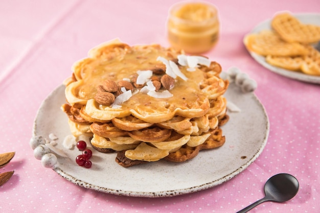 Freshly baked  heart shaped Belgium waffles European baked pastry sweets St Valentines Day