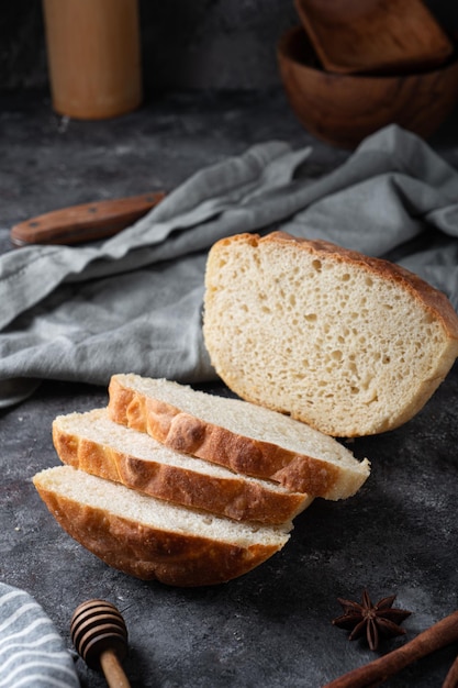 Freshly baked homemade bread with crispy crust on gray stone\
background