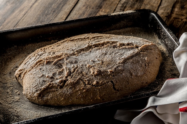 Freshly baked homemade bread on wooden background