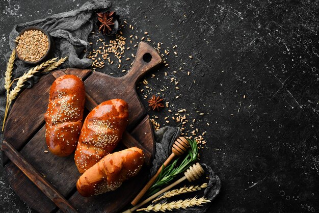 Freshly baked homemade buns with sesame Baking from rye and flour Top view Rustic style