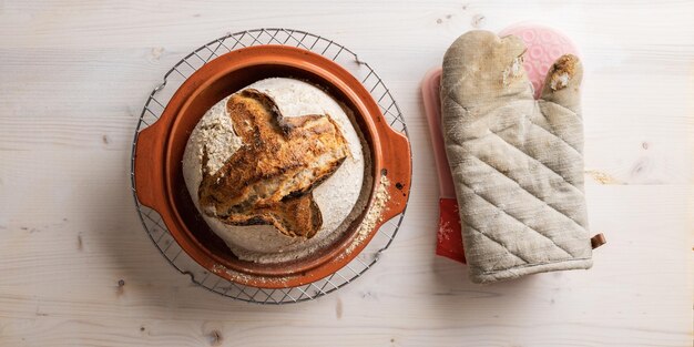 Freshly baked homemade sourdough bread in clay pot